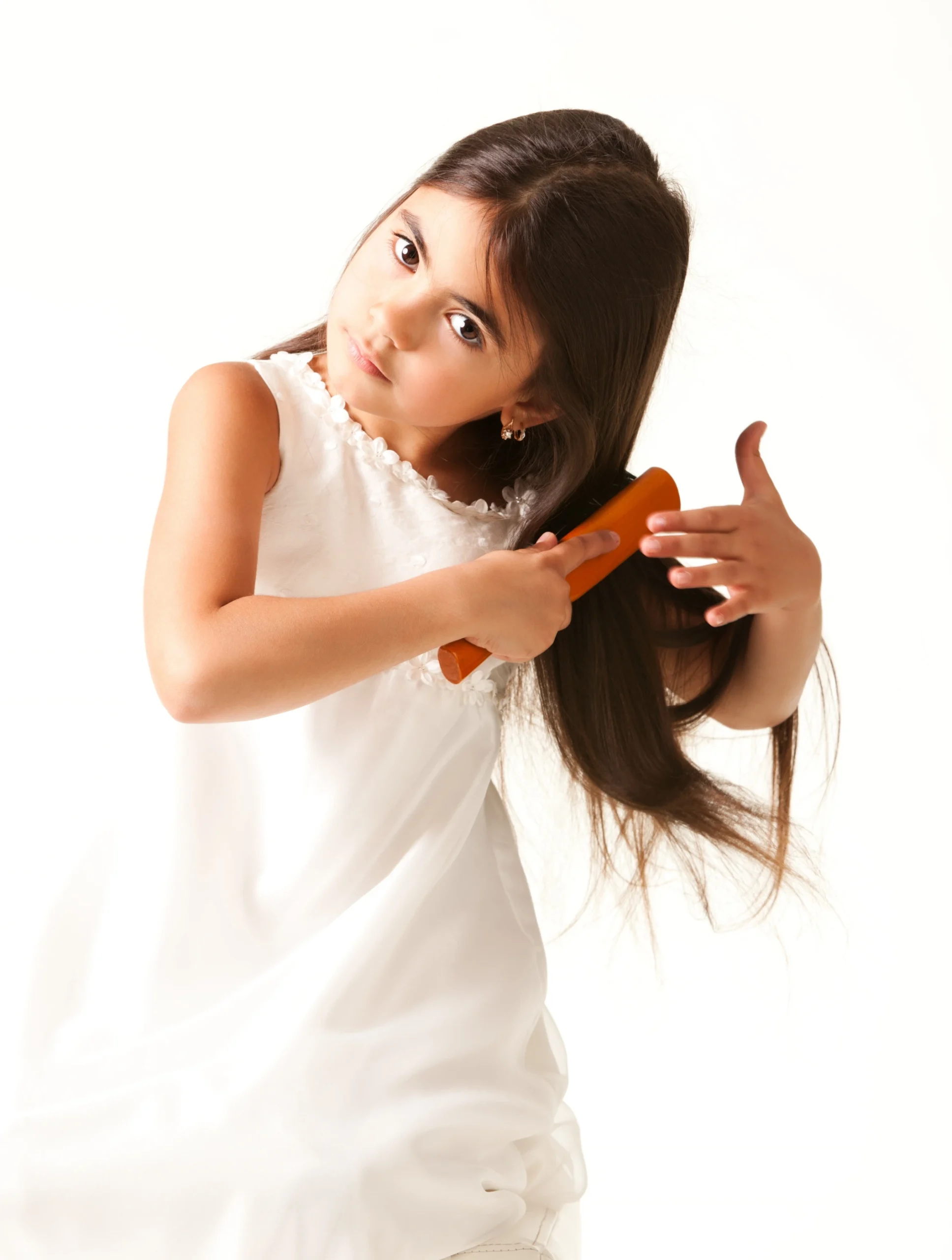 Lice Treatment Near McClellanville, SC girl in white dress combing brown hair scaled 1